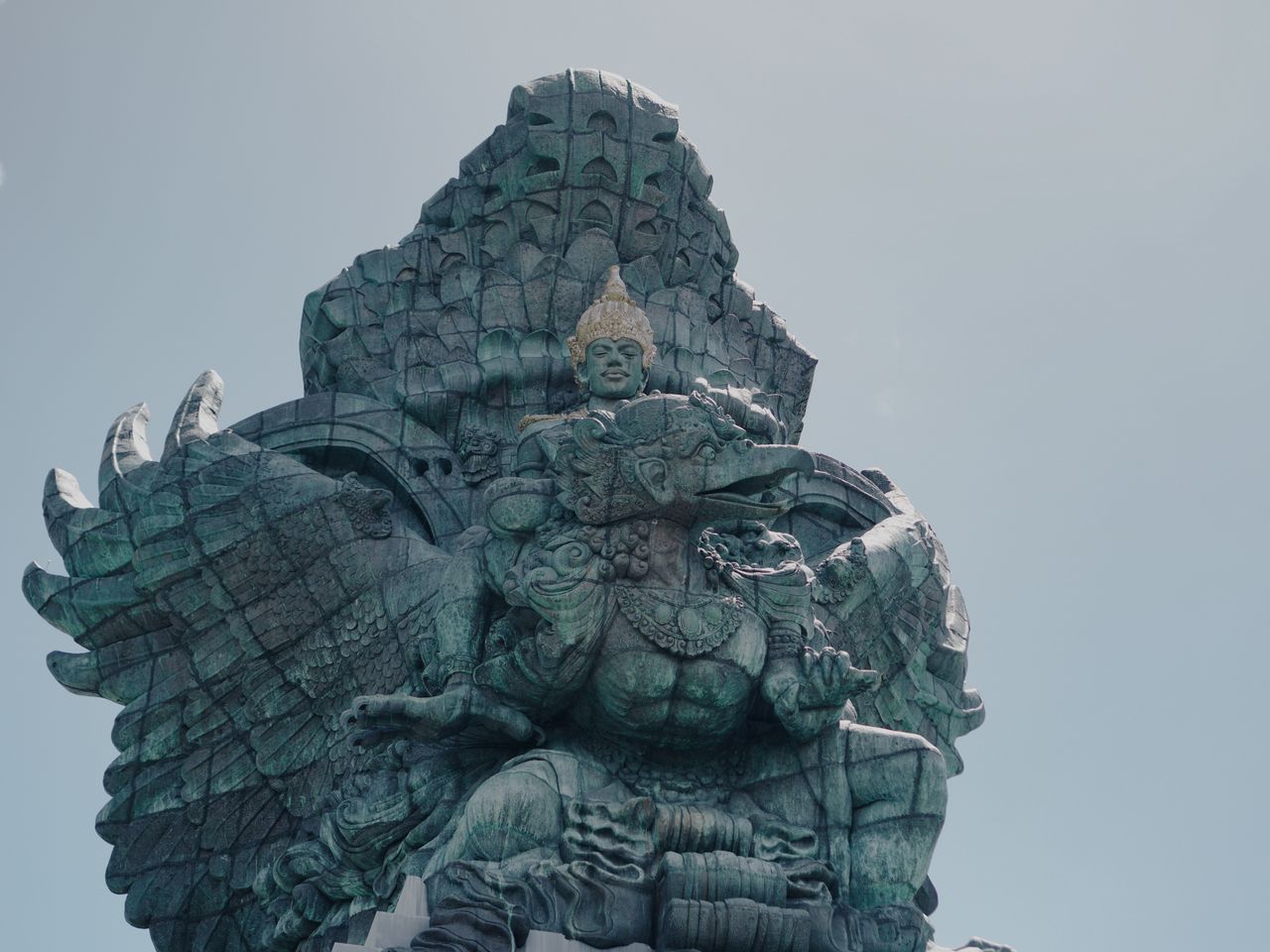 Majestic view of Garuda Wisnu Kencana statue in Bali under a clear blue sky.